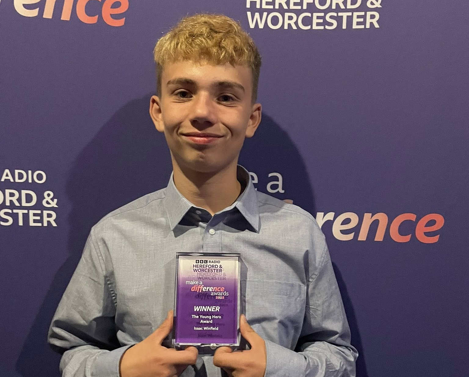 Isaac receiving an award for his food bank work